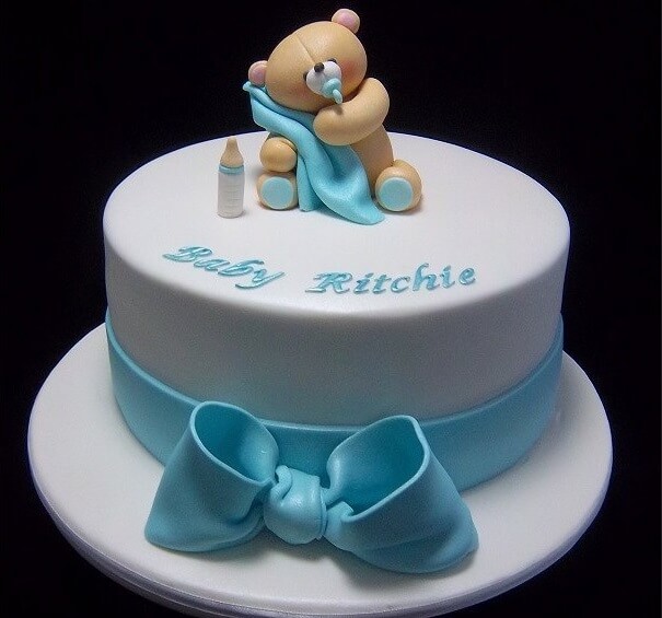 baby shower cake gender reveal cake for boy with a teddy bear on top