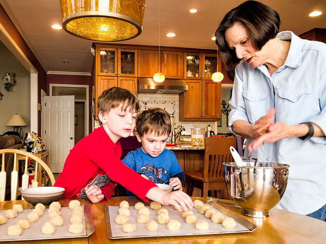 Children helping grandma make cookies