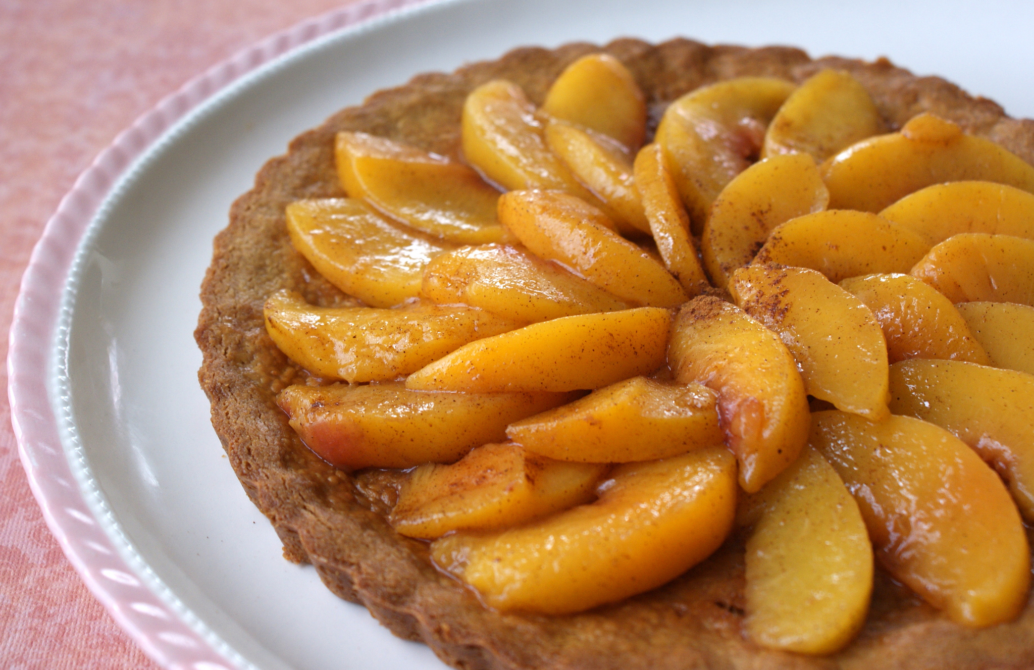 Homemade peach tart on a white plate