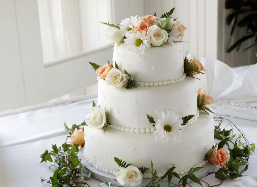 White wedding cake with flower decorations