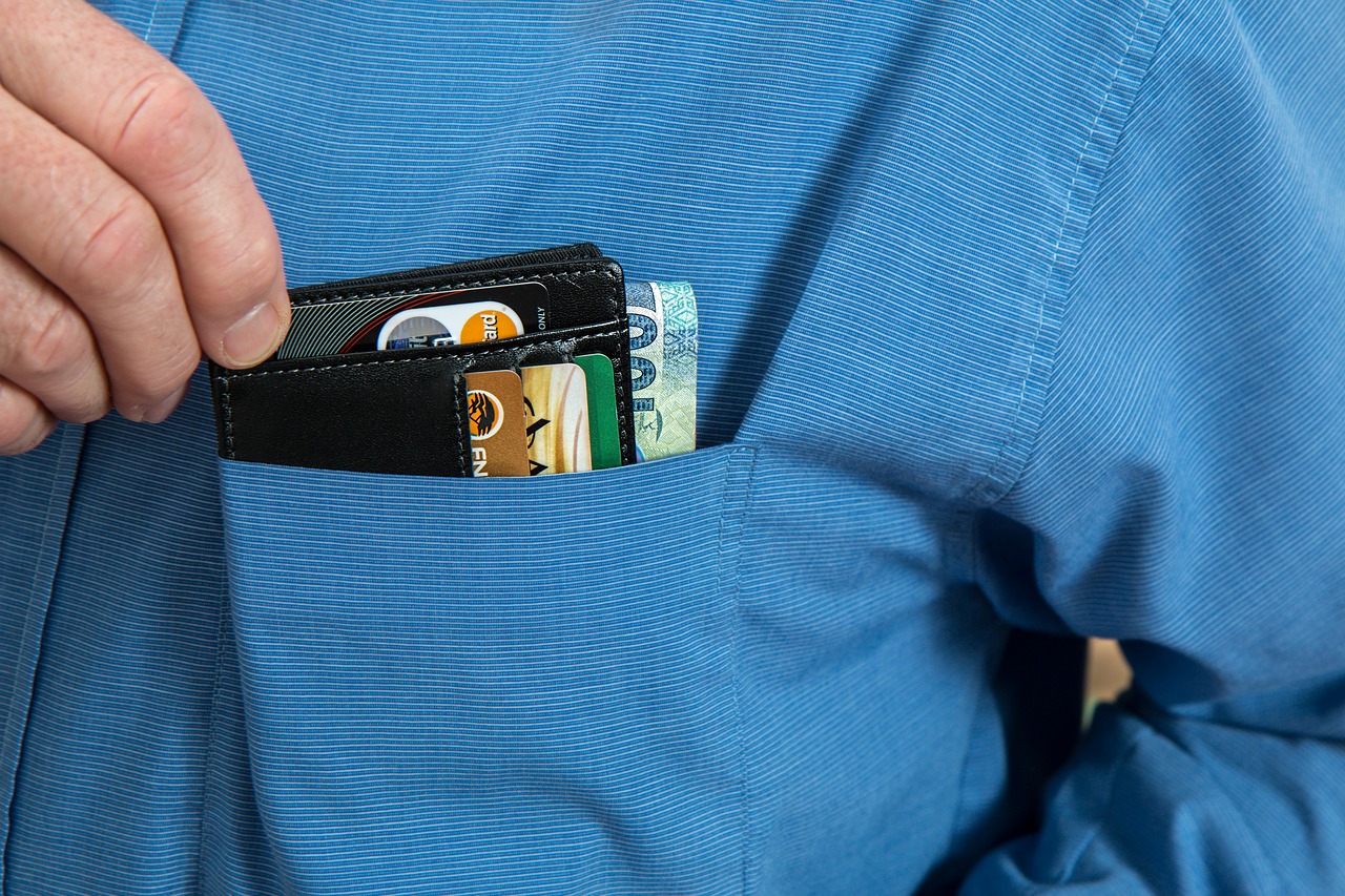 Hand picking the wallet on the pocket