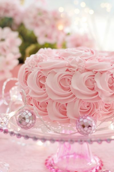 A pink cake on a pedastool