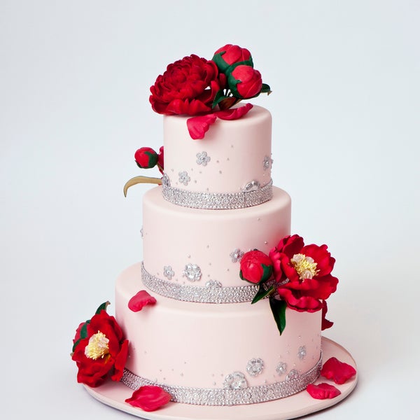 3 tier wedding cake with red flowers